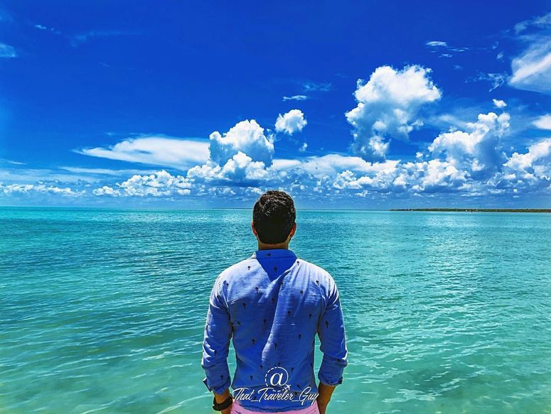 Chris looking out over turquoise water in Chetumal, Mexico